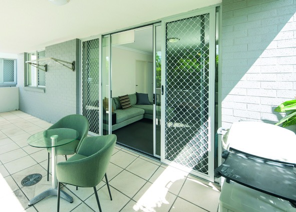 Undercover balcony with outdoor seating — calm space to step outside.