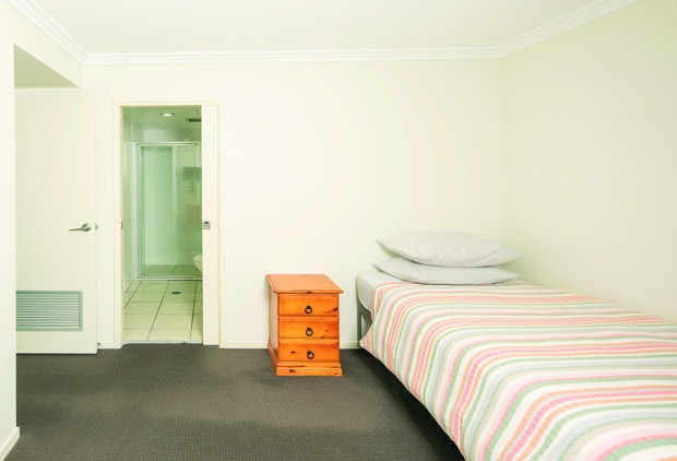 Private participant bedroom, ready for personal touches and a familiar setup.